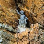 A small statue located in a crevice of the rock work of Portmeirion Villag