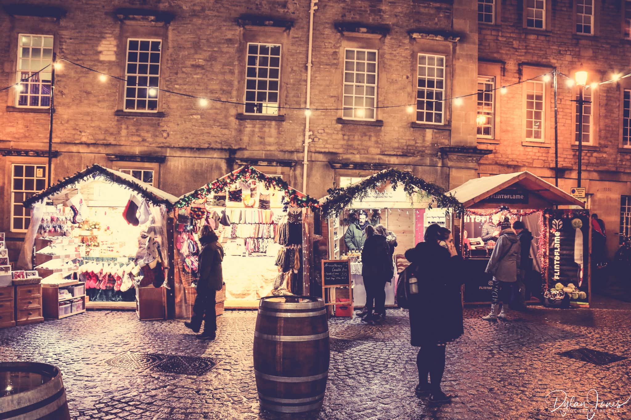 Bath Christmas Market stalls in front of the Hospital of St. John the Baptist
