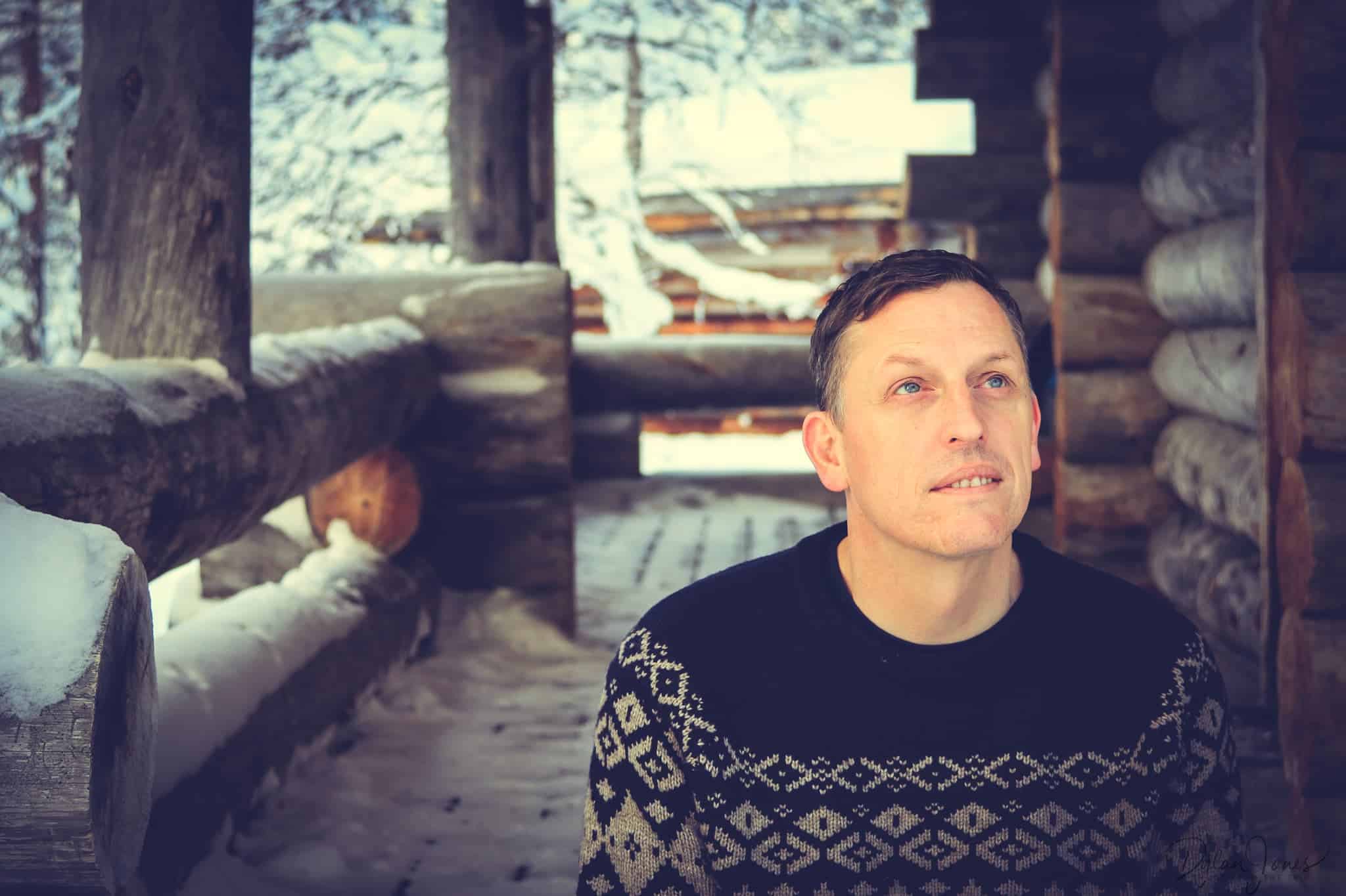 Dylan sitting on the steps of the cabin at Kakslauttanen East Village