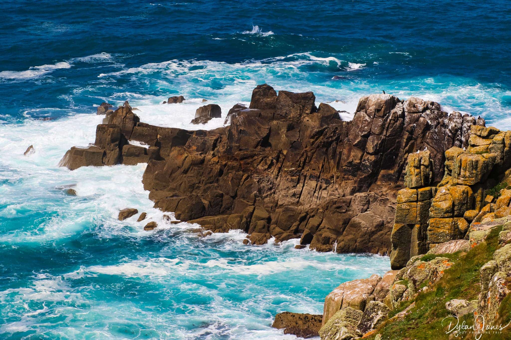 Waves crashing against the rocks at Land's End, South Cornwall coast