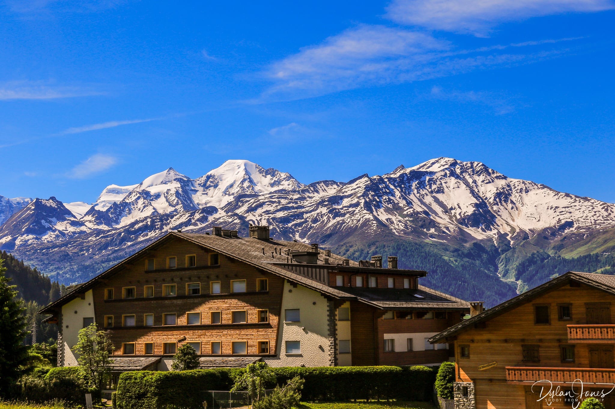 Swiss chalet style homes and snow capped mountains on a Verbier summer break