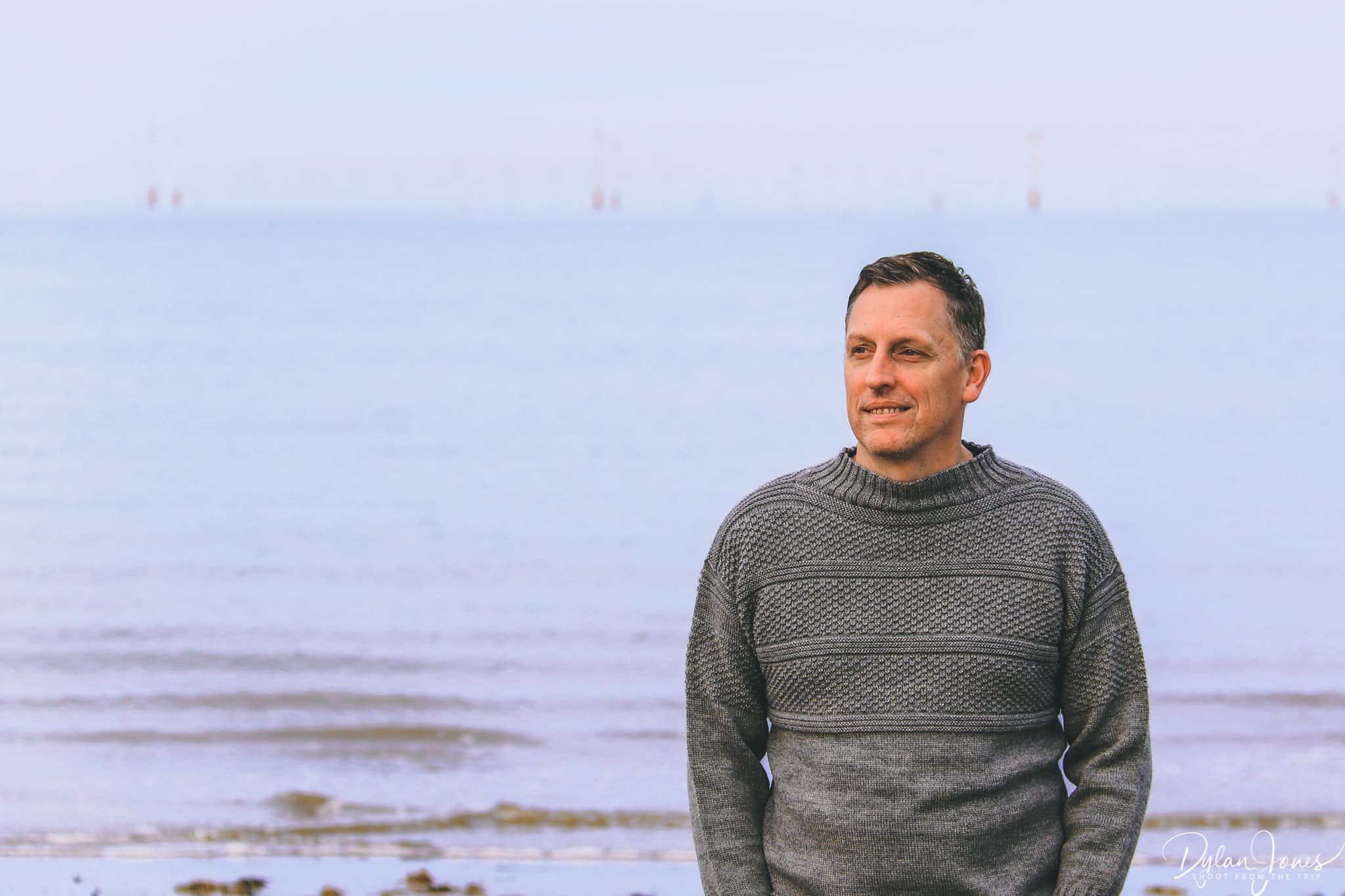 Dylan wearing a Staithes Gansey on the beach