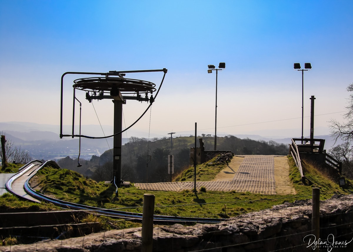 The top of the ski slope at Llandudno Snowsports Centre with a mountain backdrop