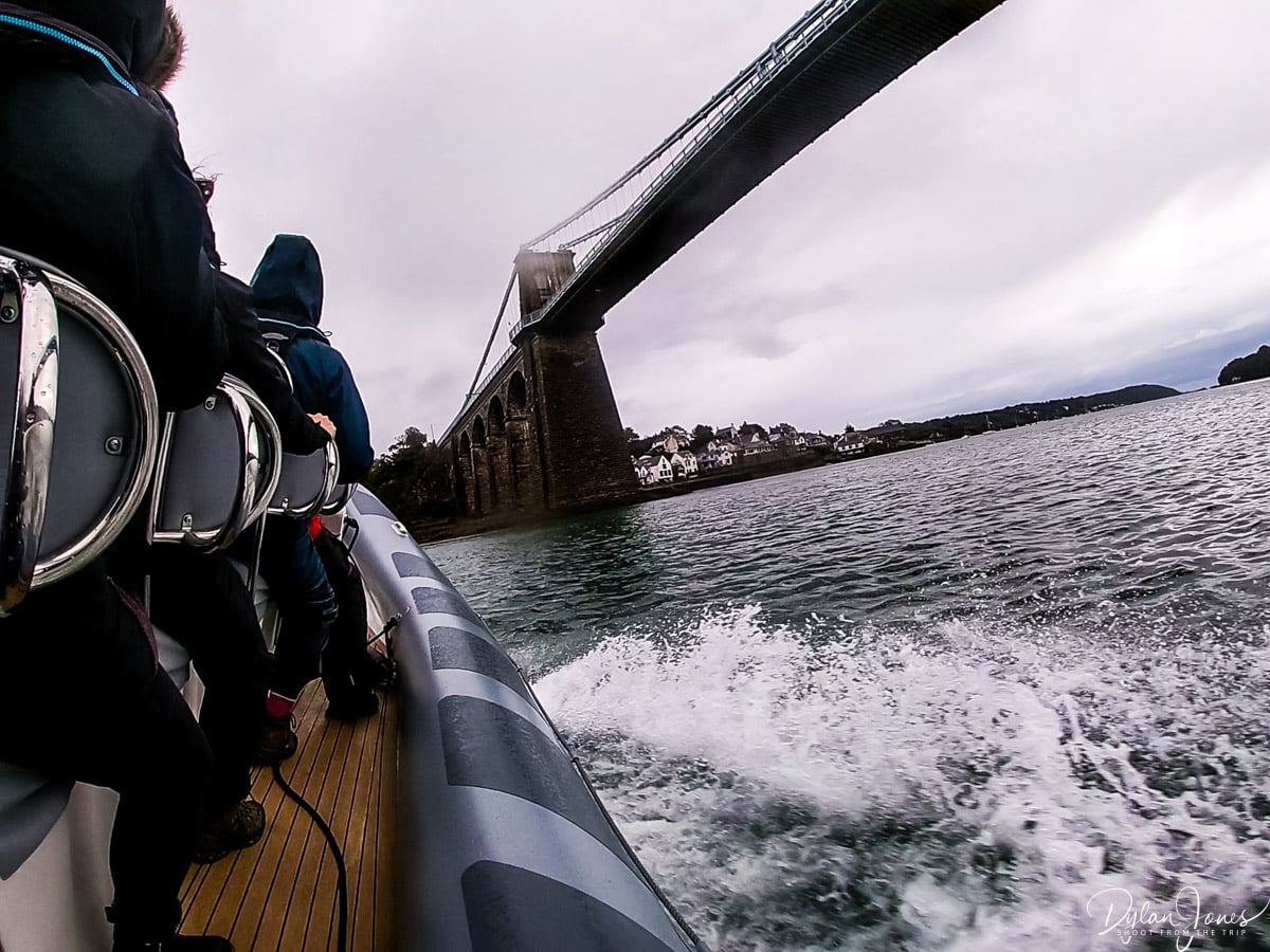 The RibRide vessel turning under Menai Bridge, on the high speed North Wales activities to get the adrenalin pumping
