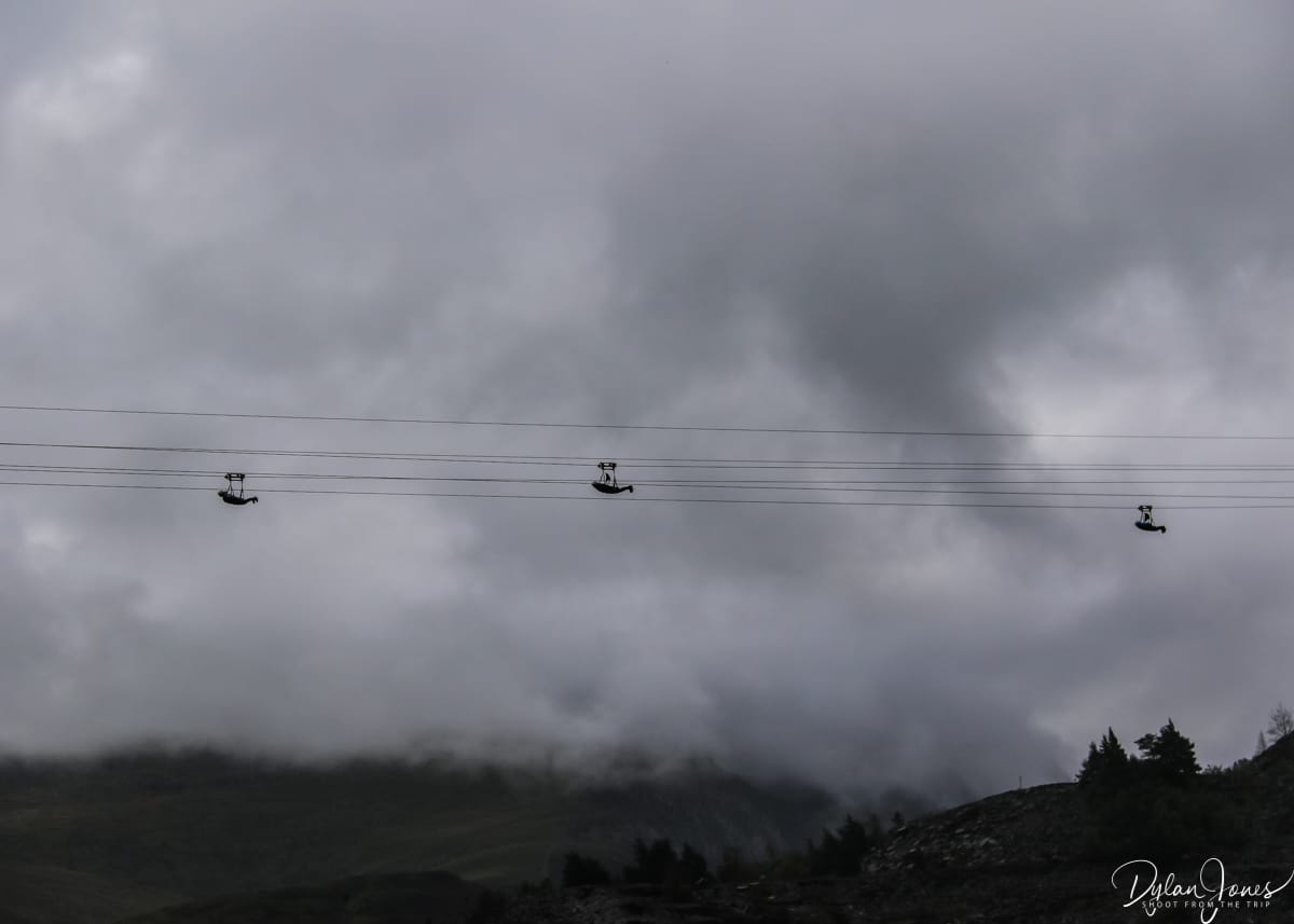 Silhouette of riders on the Velocity 2 zip wire, one of the more popular North Wales activities to get the adrenaline pumping