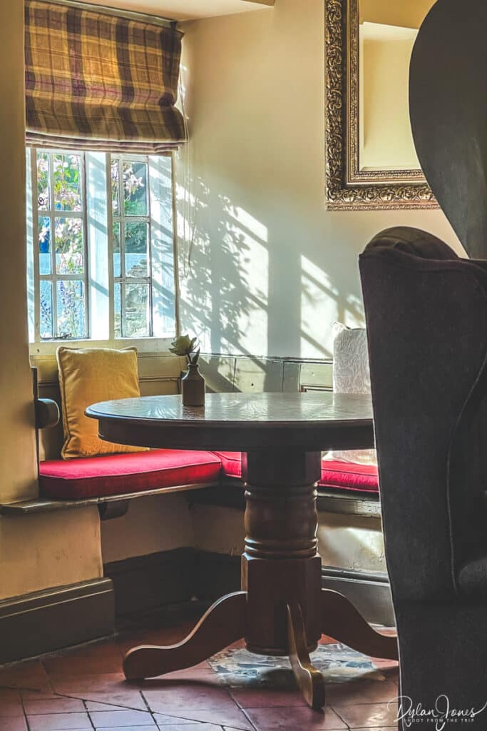 Bright sunlight cascading through a window onto a dining area