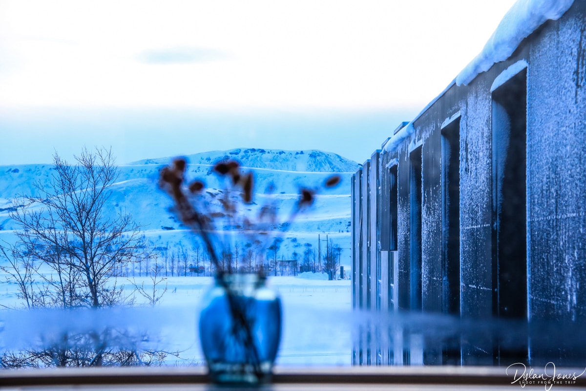 A view from the window of the hotel showing the concrete structure, with the backdrop of snowy mountains